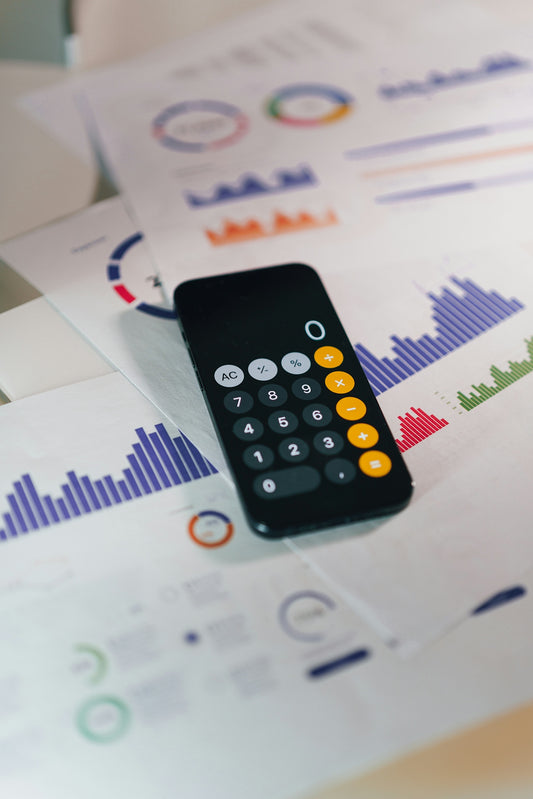 smartphone calculator app on financial report papers